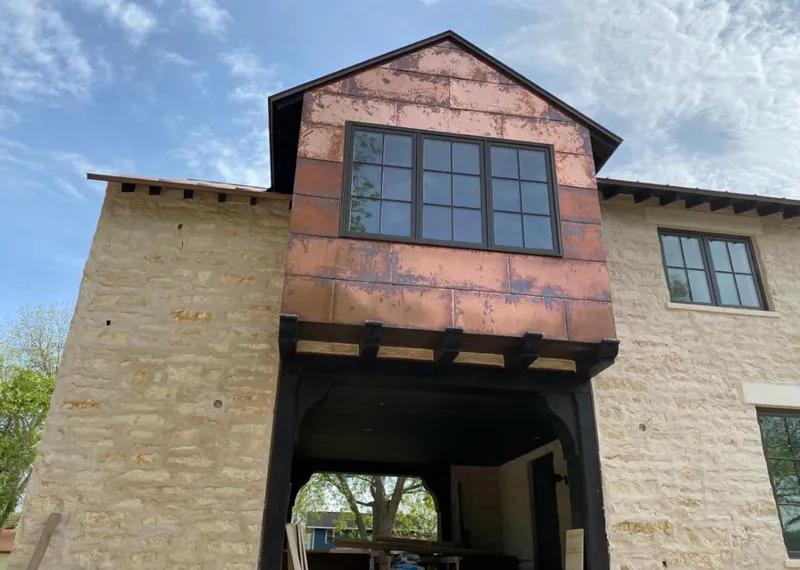 Copper metal panel facade on a stone building for Skylight Installation in Molalla